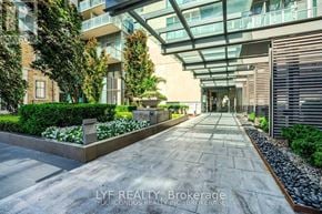 Toronto (Annex) condo for rent - A modern building with a walkway in front of it.