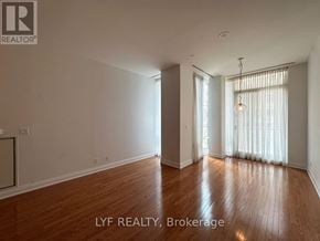 Toronto (Annex) condo for rent - A room with wooden flooring and a window with curtains.