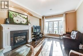 Mississauga (Lakeview) apartment for rent - A living room with a fireplace and a painting of flowers on the wall.