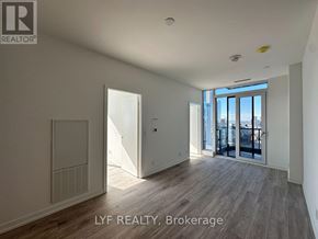Toronto (Waterfront Communities) condo for rent - A room with a sliding glass door leading to a balcony.
