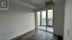 Toronto (Moss Park) condo for rent - A room with a sliding glass door leading to a balcony.