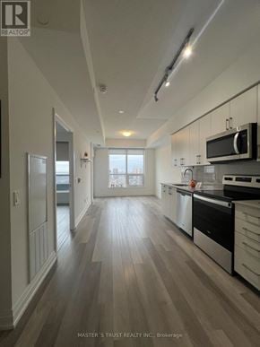 Toronto (Tam O'shanter-Sullivan) condo for rent - A kitchen with wood floors and white cabinets.
