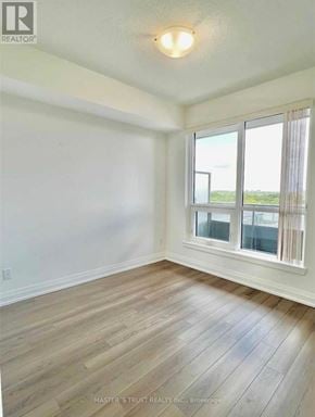 Toronto (Tam O'shanter-Sullivan) condo for rent - A room with a window and wooden flooring.