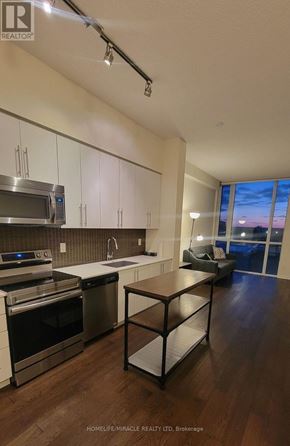 Mississauga (Creditview) condo for rent - A kitchen with white cabinets and a wooden island.