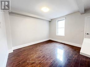 Toronto (Dovercourt-Wallace Emerson-Junction) apartment for rent - A room with wooden flooring and a window letting in sunlight.