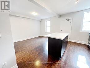 Toronto (Dovercourt-Wallace Emerson-Junction) apartment for rent - A room with a black countertop and wooden flooring.