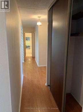 Mississauga (Cooksville) condo for rent - A hallway with wood floors and white walls.