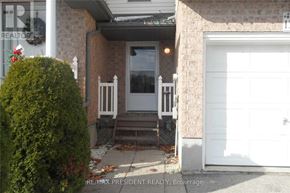 Kitchener townhouse for rent - A house with a white door and a white garage door.