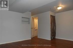 Kitchener townhouse for rent - A room with a door and a window with curtains.