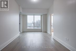 Ottawa condo for rent - A spacious room with a large window and wooden flooring.