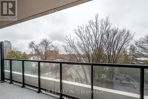 Ottawa condo for rent - A balcony with a glass railing and a view of houses and trees.