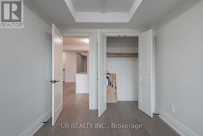 Ottawa condo for rent - A room with a white door and a wooden floor.