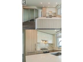 Burnaby apartment for rent - A modern kitchen with a large island and a staircase leading to the upper level.