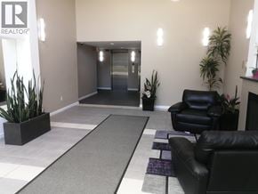 Burnaby apartment for rent - A black leather chair sits in a waiting area with a purple rug.
