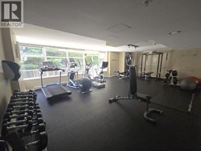 Burnaby apartment for rent - A gym with a variety of equipment including weights and cardio machines.