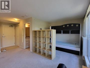 Burnaby apartment for rent - A bedroom with a built-in bed and shelves.