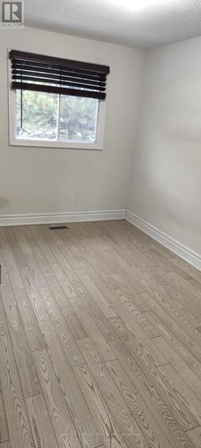 Toronto (Agincourt North) apartment for rent - A room with wooden flooring and a window with blinds.