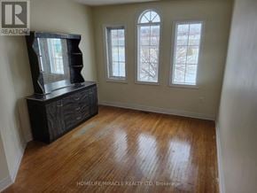 Vaughan (Maple) townhouse for rent - A room with a wooden floor and a large mirror cabinet.