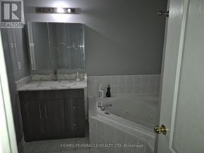 Vaughan (Maple) townhouse for rent - A bathroom with a sink, mirror, and bathtub.