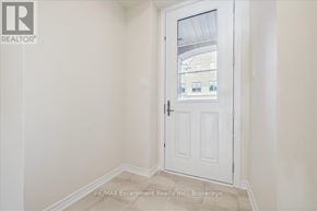 Burlington (Tyandaga) townhouse for rent - A white door with a glass window is in a room with white walls.