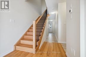 Burlington (Tyandaga) townhouse for rent - A hallway with a staircase and a door at the end.