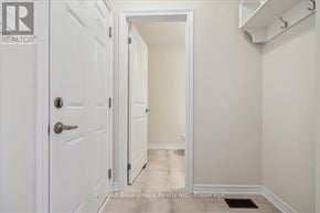 Burlington (Tyandaga) townhouse for rent - A white door with a handle and a brokerage sign on the wall.