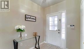 Brampton (Gore Industrial North) apartment for rent - A hallway with a glass table and a white door.