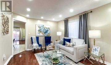 Brampton (Gore Industrial North) apartment for rent - A living room with a white couch and blue chairs.