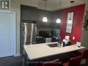 Brampton (Goreway Drive Corridor) condo for rent - A kitchen with a stainless steel refrigerator and a white countertop.
