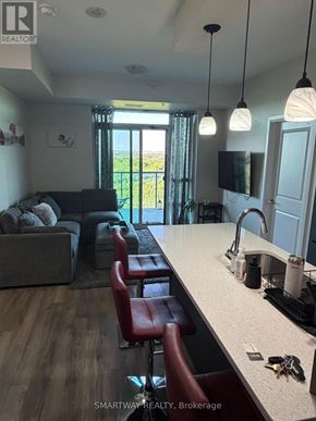 Brampton (Goreway Drive Corridor) condo for rent - A real estate listing photo of a kitchen and living room.