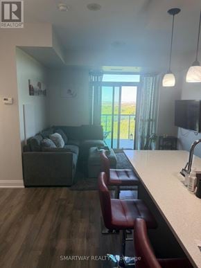 Brampton (Goreway Drive Corridor) condo for rent - A living room with a couch, a chair, and a television.
