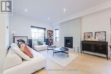 Toronto (Mount Pleasant East) apartment for rent - A living room with a white couch and a fireplace.