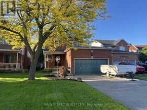Georgina (Keswick North) apartment for rent - A tree with yellow leaves stands in front of a brick house.