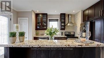 Mississauga (Lakeview) apartment for rent - A kitchen with a marble countertop and dark wood cabinets.