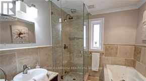 Mississauga (Lakeview) apartment for rent - A bathroom with a sink, mirror, and bathtub.
