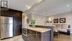 Mississauga (Lakeview) apartment for rent - A kitchen with a granite countertop and a refrigerator.