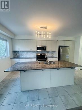 Kitchener townhouse for rent - A kitchen with granite countertops and white cabinets.