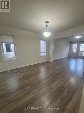 Kitchener townhouse for rent - A room with wooden flooring and a window with blinds.