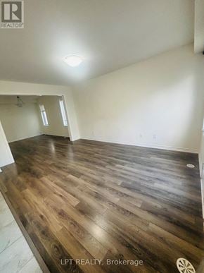 Kitchener townhouse for rent - A room with wooden flooring and a white ceiling.