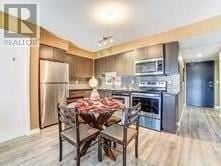 Toronto (Wexford-Maryvale) condo for rent - A modern kitchen with a dining table set for two.
