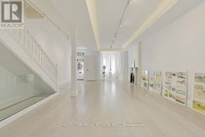 Toronto (Annex) apartment for rent - A real estate office with a white staircase and a wall of posters.