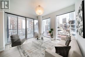 Toronto (Church-Yonge Corridor) condo for rent - A living room with a couch, chair, and a table with a plant on it.
