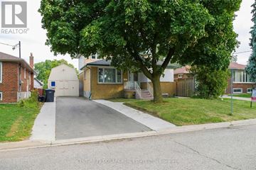 Brampton (Brampton North) apartment for rent - A tree-lined street with a house and a sign for Century 21 Skyland Real Estate.