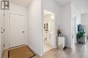 Burlington (Freeman) condo for rent - A white interior of a room with a door, a cabinet, and a plant.