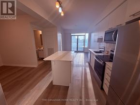 Grimsby (Grimsby Beach) condo for rent - A kitchen with a white island in the middle of the room.