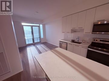 Grimsby (Grimsby Beach) condo for rent - A kitchen with white cabinets and a wooden floor.