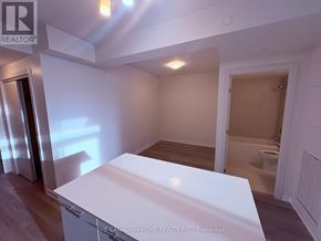 Grimsby (Grimsby Beach) condo for rent - A white kitchen island in a room with a toilet in the background.
