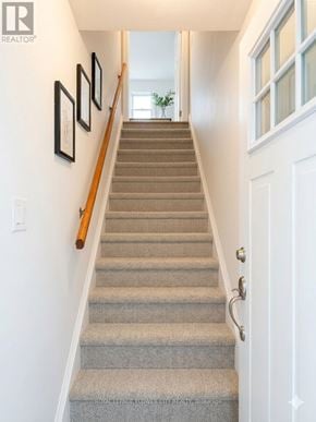 London North (North N) apartment for rent - A staircase with a beige carpet and a white door.