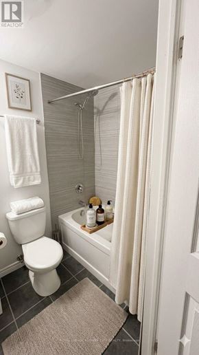 London North (North N) apartment for rent - A white toilet sits next to a bathtub in a bathroom.