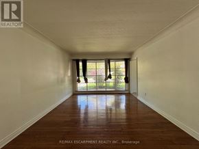 Hamilton (Balfour) apartment for rent - A long hallway with wood floors and white walls.